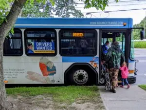 A family getting on an Advance Transit Bus.
